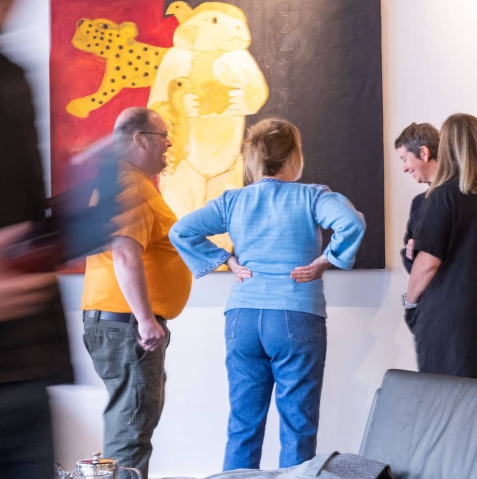 group of people in front of art