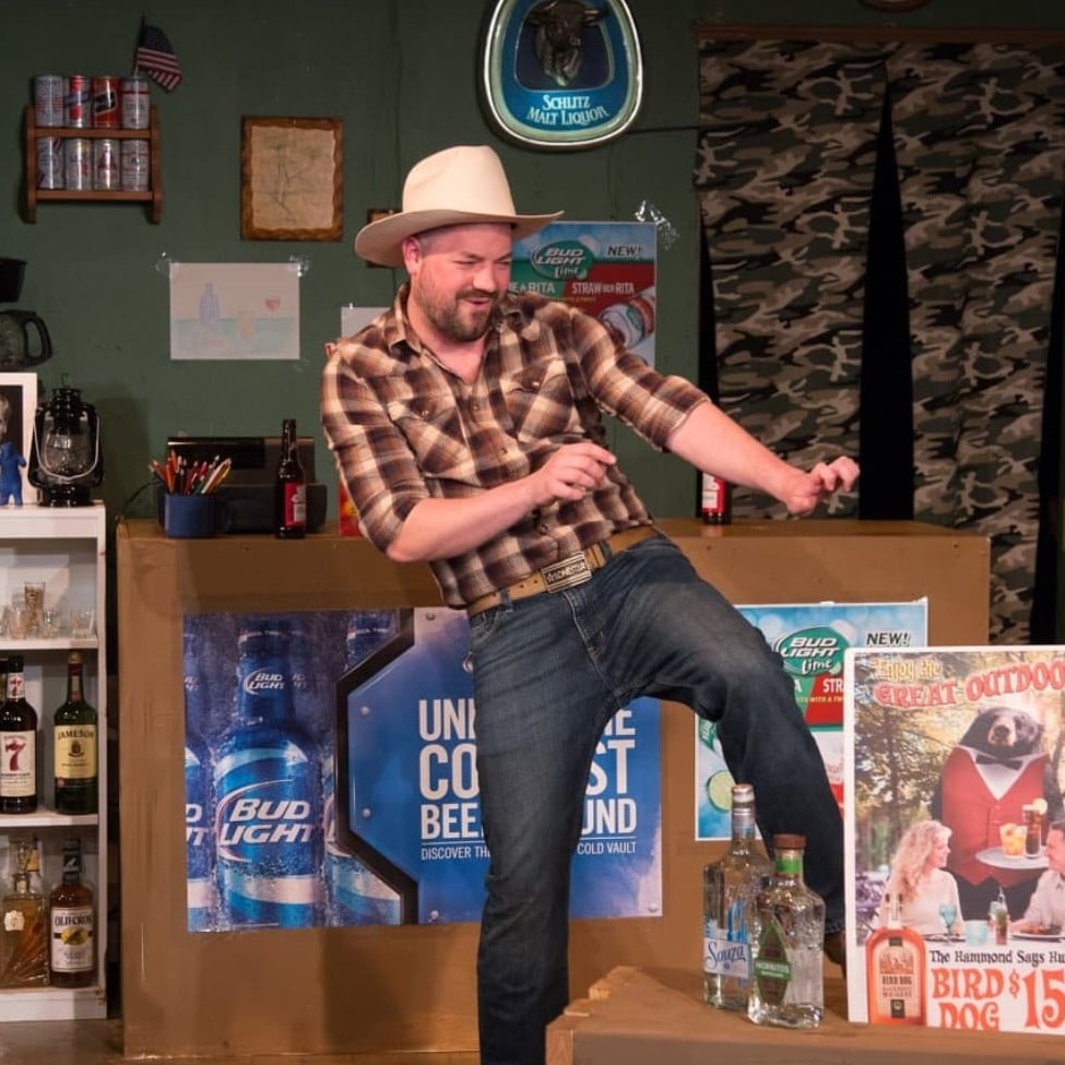 man dressed like cowboy on stage